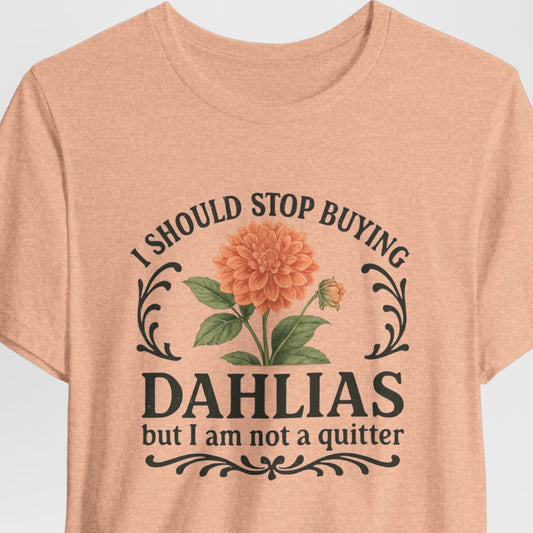 Peach t-shirt with floral design and text on a light gray background
