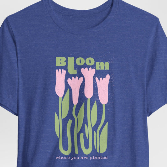 Blue t-shirt with pink tulips and 'Bloom where you are planted' text on a white background