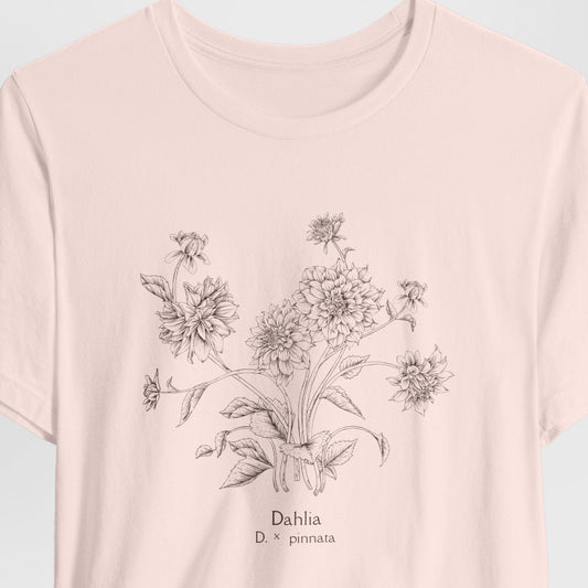 Pink t-shirt with floral design and text on a light gray background